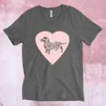 An image of a charcoal grey t-shirt with a large pink heart across the chest and a grey dachshund dog on the heart.