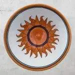 Flaming Orange Sun on White Pottery Bowl with Blue and Gold Rim