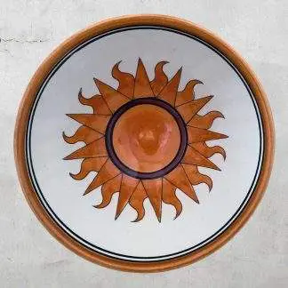 Flaming Orange Sun on White Pottery Bowl with Blue and Gold Rim