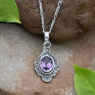 A photo of our Oxidized Sterling Silver Pendant with oval faceted amethyst gemstone in a vintage flair.