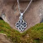 An image of a pendant with four triquetra or trinity celtic knots interwoven in sterling silver. The pendant has a total drop of .813 inches by a width of .50 inches