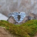 an image of a sterling silver ring of two angel wings forming a heart