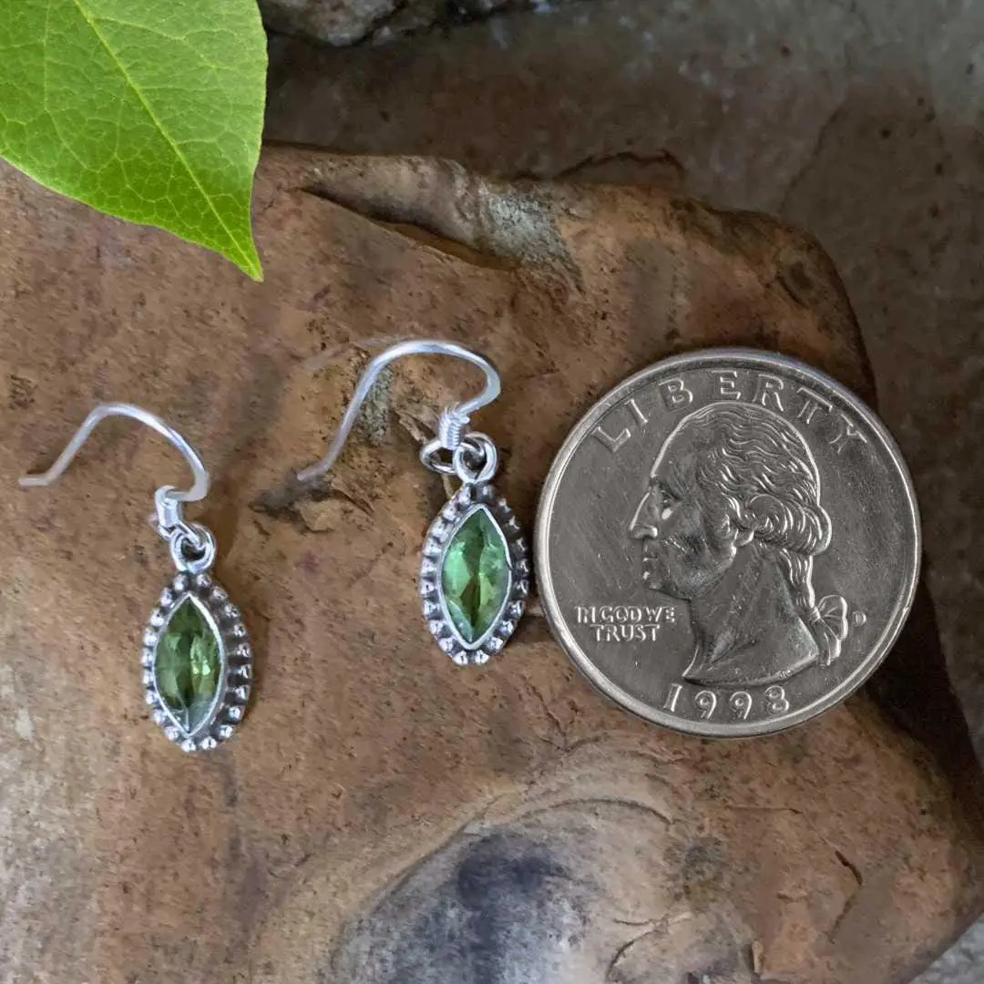 an image of a pair of Marquise Peridot and Sterling Silver Dangly Earrings next to a quarter with dimensions of 28 mm X Width: 7 mm