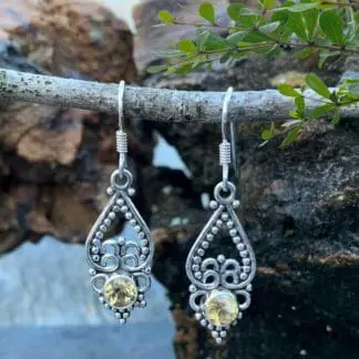 an image of a pair of sterling silver earrings with an upside down open heart and silver beadwork and a small round faceted citrine gemstone at the bottom.