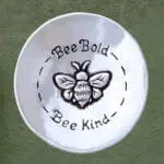 an image of a Pewter Bee Lovers Charm Bowl that has a bee in the center and says Bee Bold, Bee Kind and is 3 x 3 inches in diameter