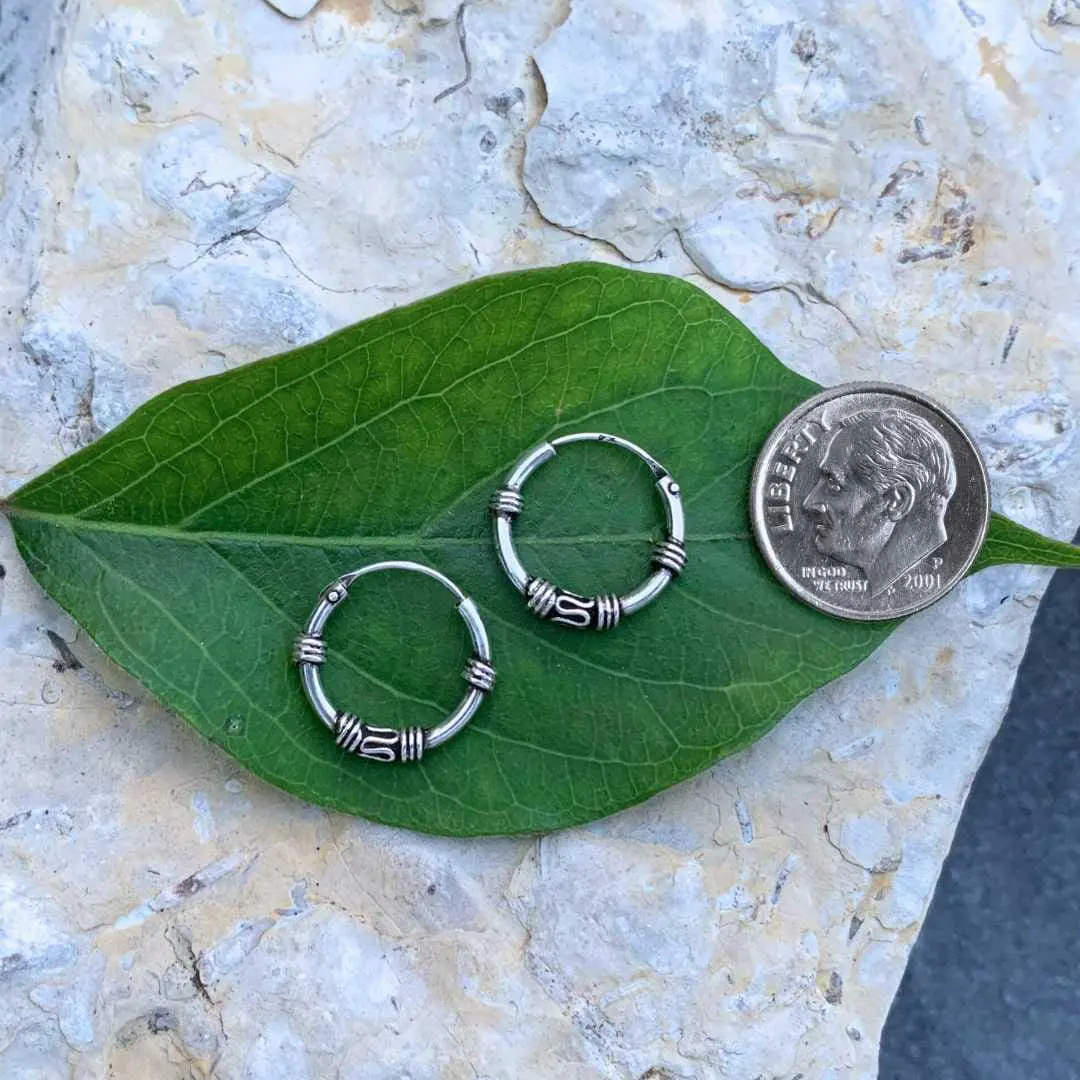an image of a pair of Small Sterling Silver Bali Hoop Earrings next to a dime