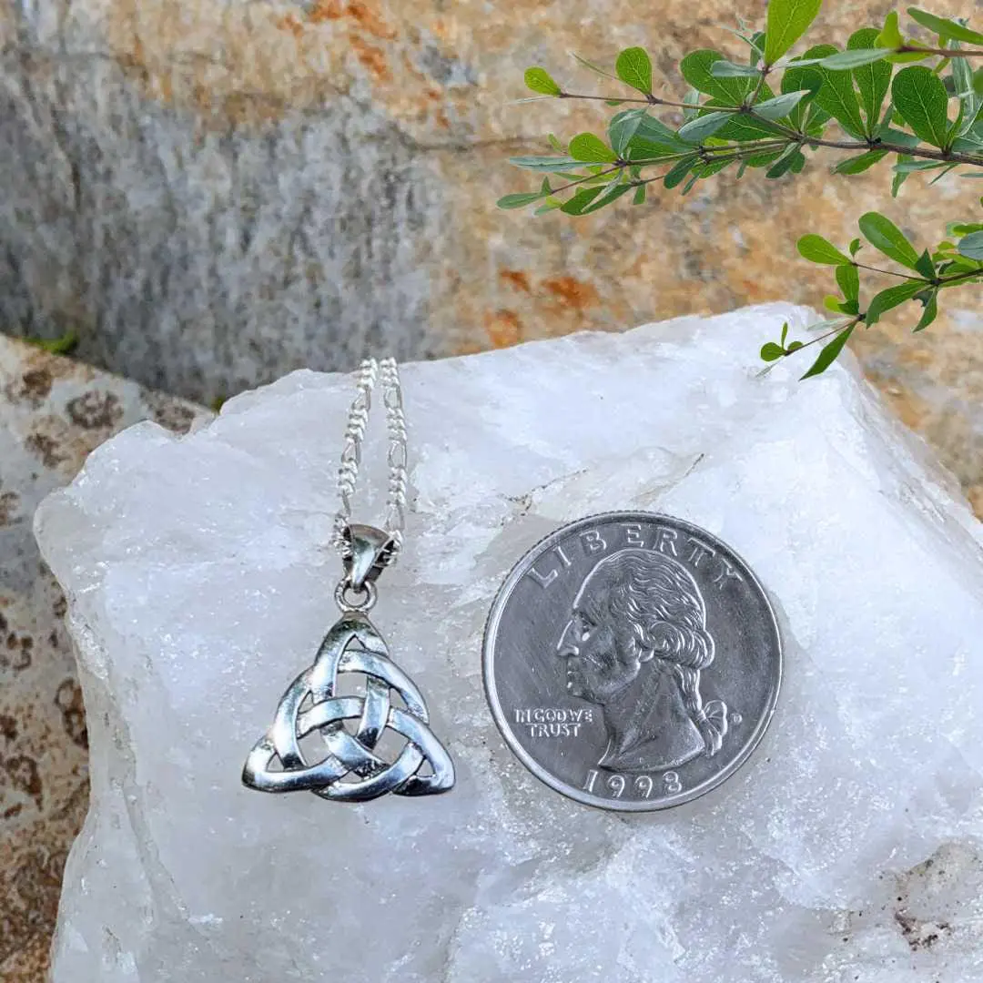 an image of a Sterling Silver Triquetra Celtic Knot Pendant next to a quarter