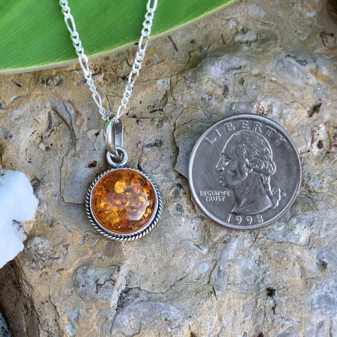 An image of a Round Amber and Sterling Silver Pendant that is .59 inches in diameter