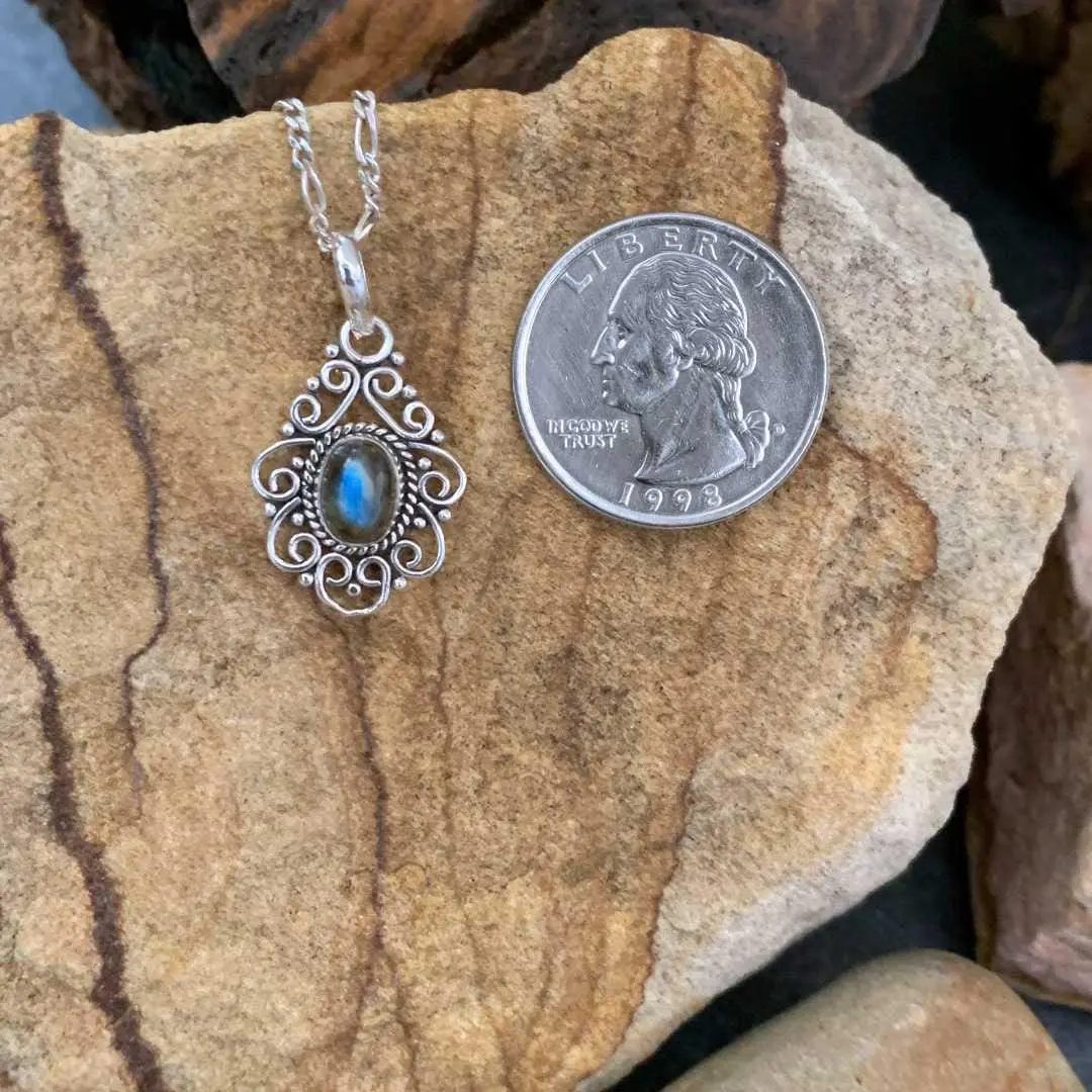 an image of a Filigree Sterling Silver and Labradorite Pendant next to a quarter
