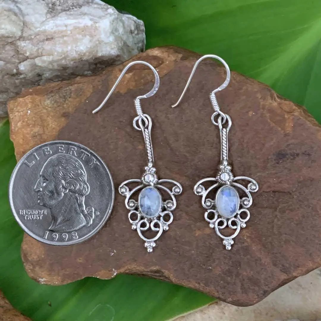 an image of a pair of Sterling Silver and Rainbow Moonstone Feminine Earrings next to a quarter