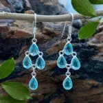 an image of a pair of Blue Topaz and Sterling Silver Chandelier Earrings with 4 teardrop shaped faceted blue topaz gemstones