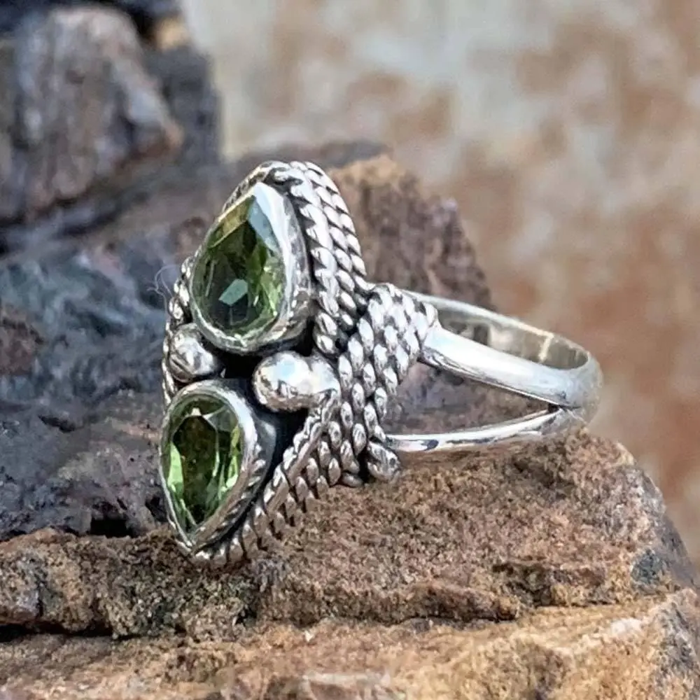 an image of a side view of a Double Faceted Peridot and Sterling Silver Ring