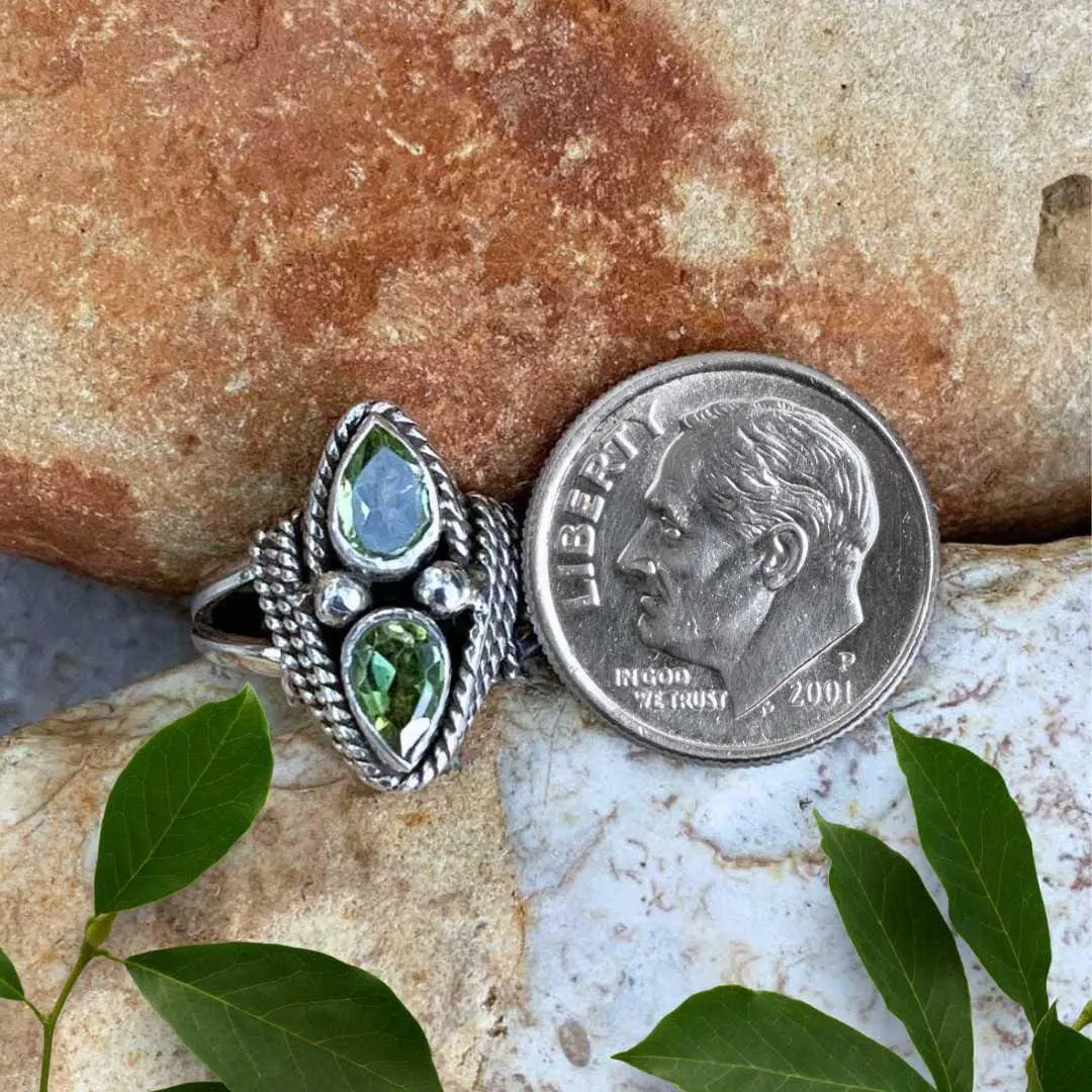 an image of a Double Faceted Peridot and Sterling Silver Ring next to a dime