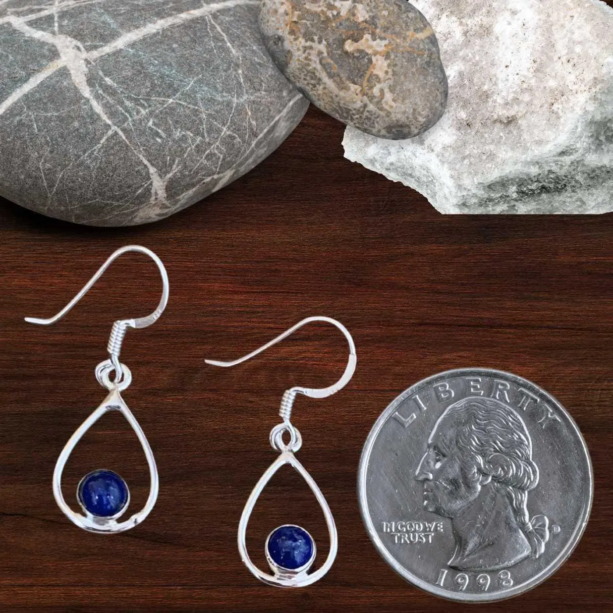 an image of a pair of Open Oval Sterling Silver and Round Lapis Lazuli Earrings next to a quarter