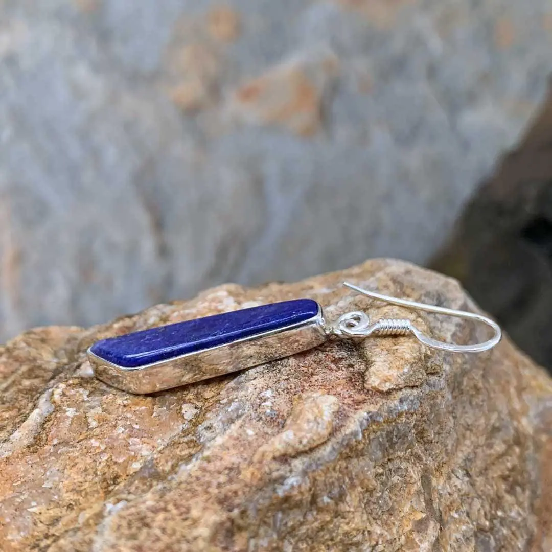 an image of a an image of a Contemporary Lapis Lazuli and Sterling Silver Dangle Earrings with an angled cut at the bottom side view to show sterling setting