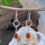 An image of a pair of Hammered Sterling Circle with Carnelian Teardrop Earrings