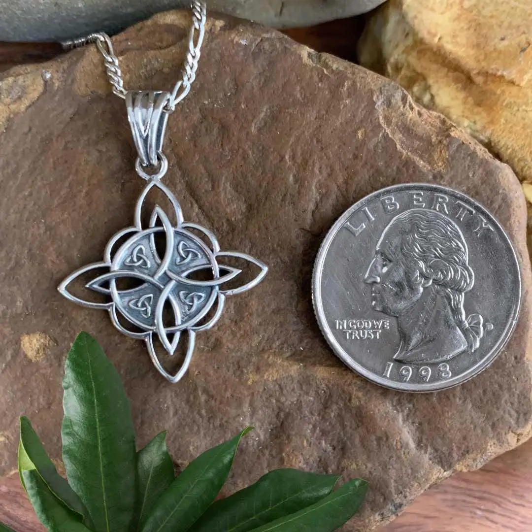 an image of our Four Triquetras Celtic Sterling Silver Pendant next to aquarter