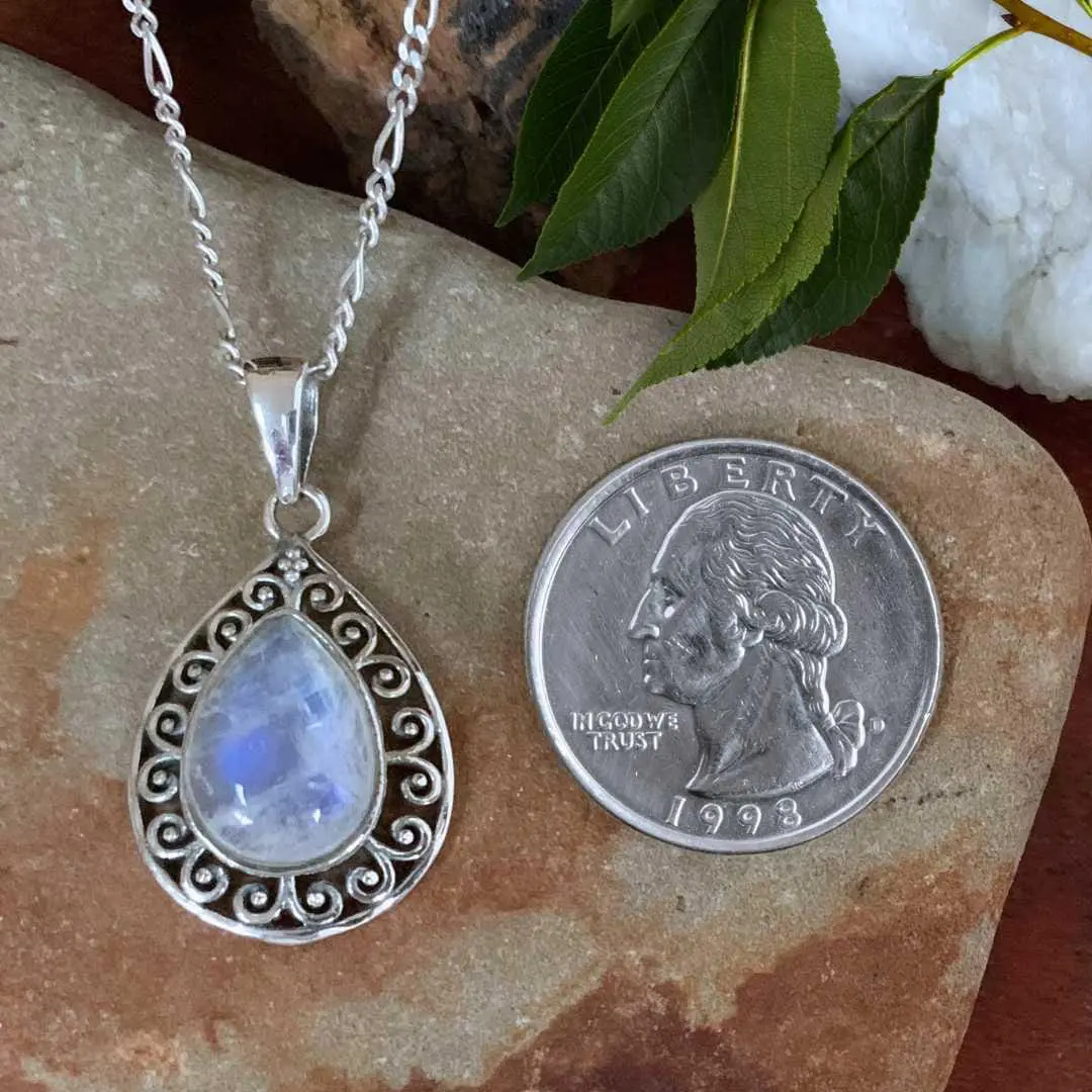 an image of a Teardrop Rainbow Moonstone Filigree Sterling Silver Pendant next to a quarter
