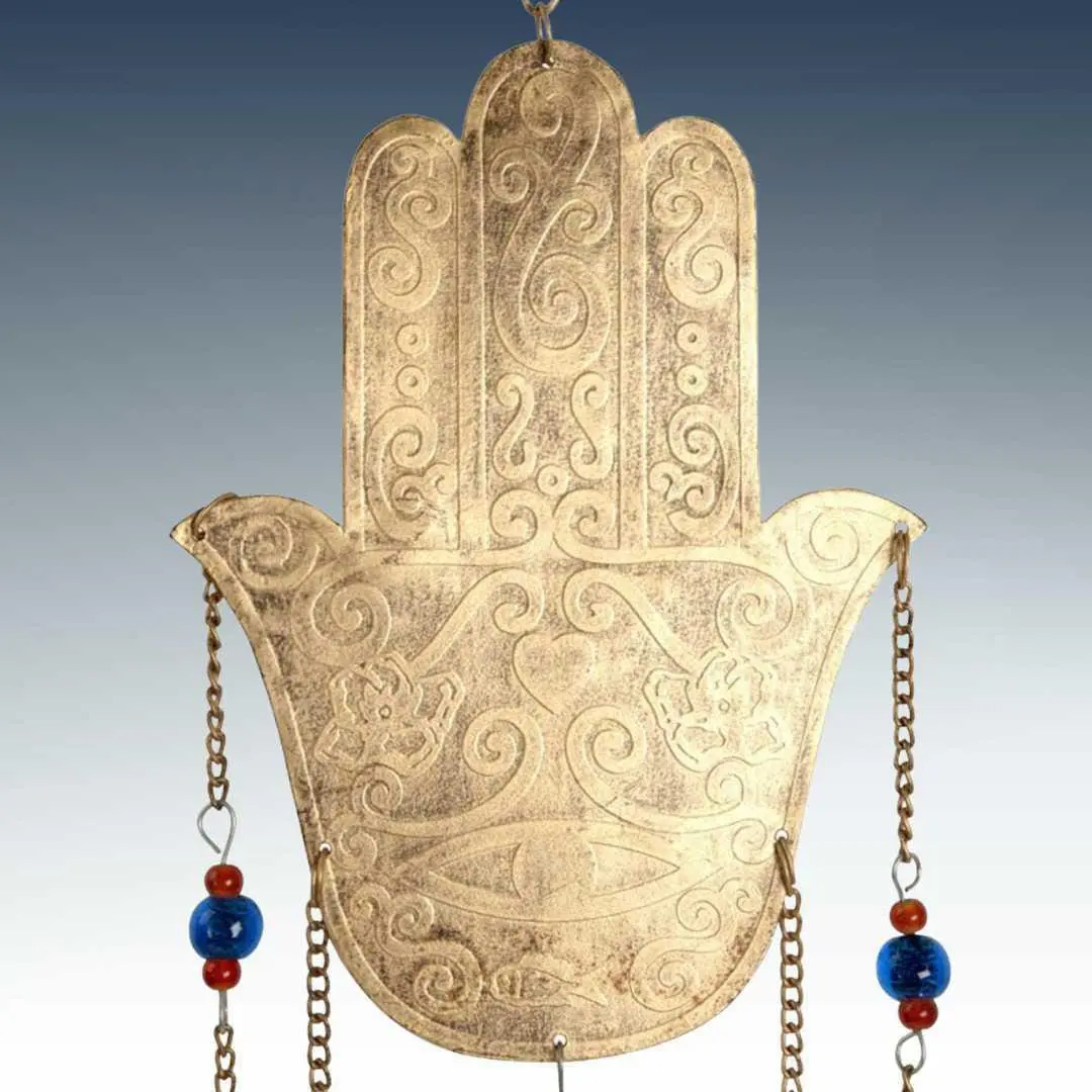 an image of a closeup view of the hamsa on our Recycled Metals Hamsa Wind Chime