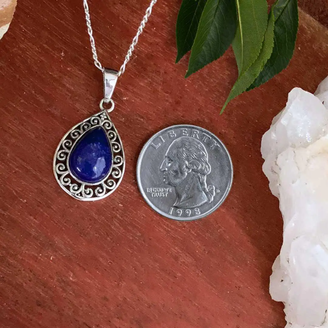 an image of a Teardrop Lapis Lazuli Filigree Sterling Silver Pendant next to a quarter