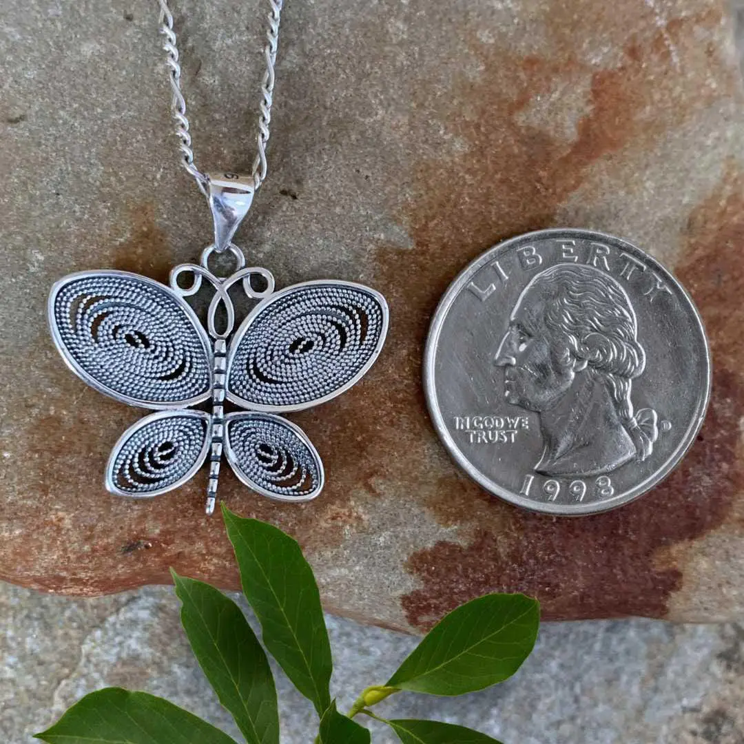 an image of a Beaded Sterling Silver Open Heart Earrings next to a quarter