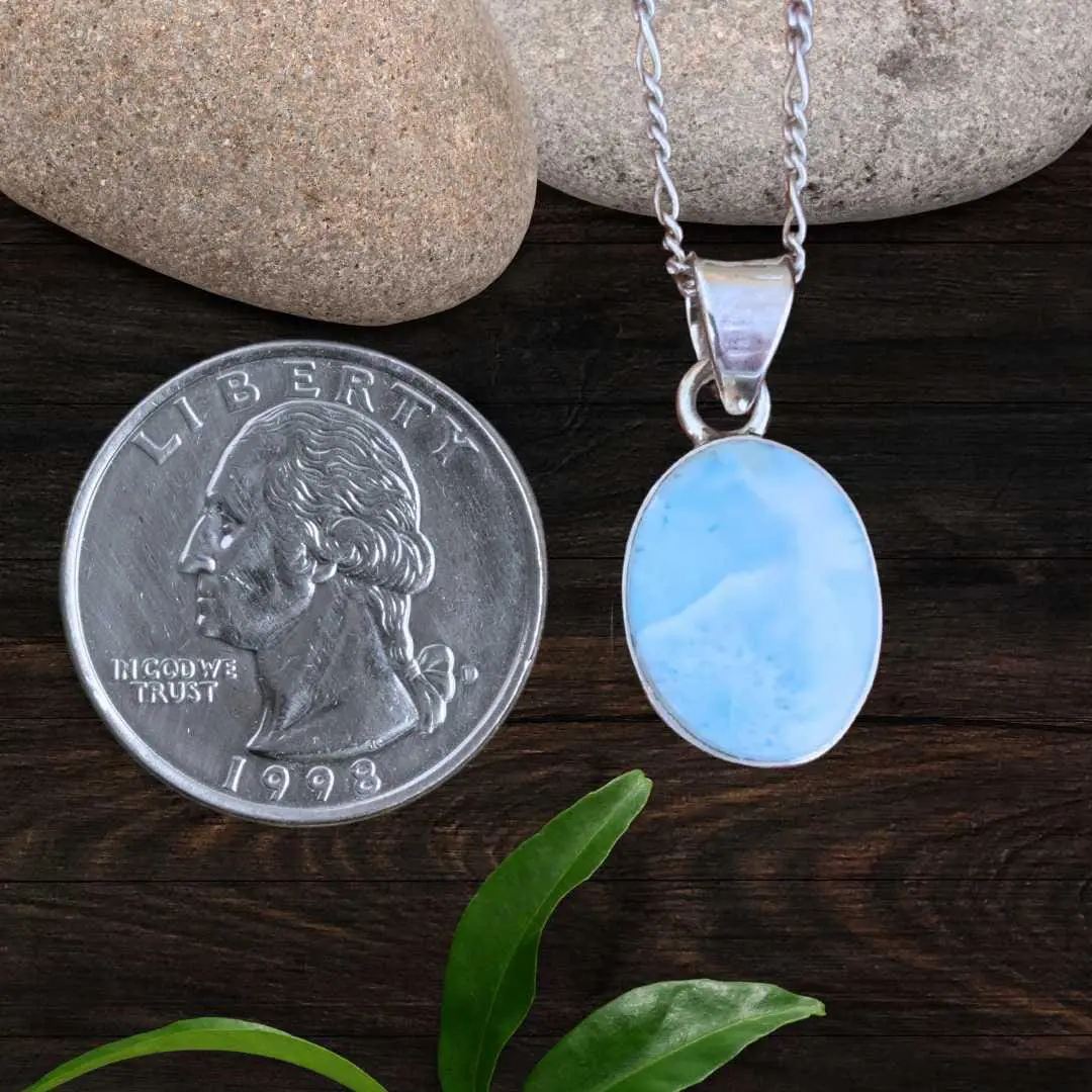 an image of a Dainty Oval Larimar and Sterling Silver Pendant next to a quarter