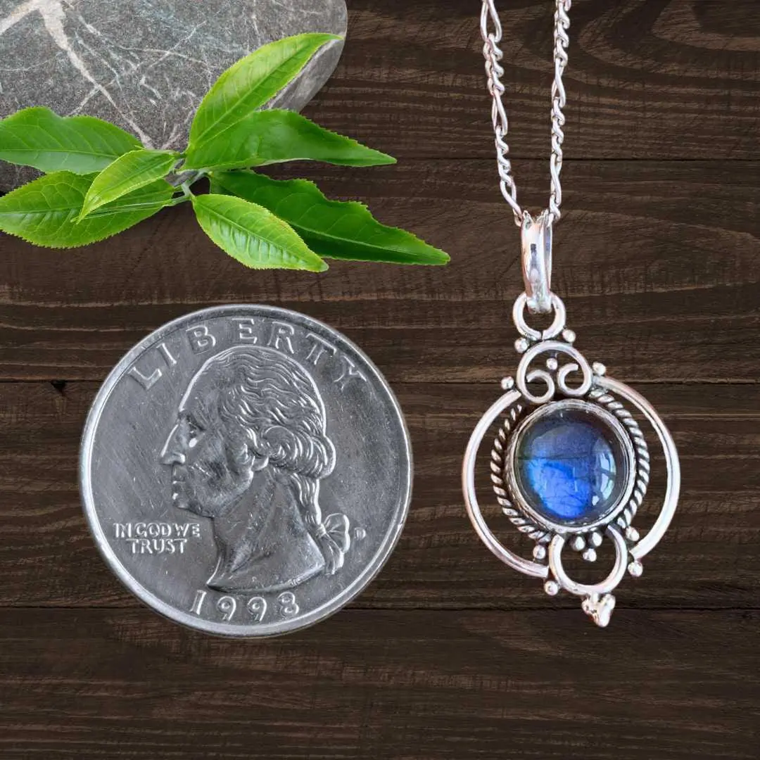 an image of a Feminine Labradorite and Sterling Silver Pendant next to a quarter