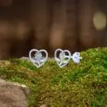 an image of a sterling silver sunflower in an open sterling silver heart stud earrings