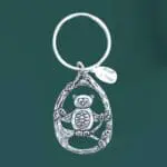 an image of an owl in tree pewter keychain. The owl is in the center of some branches and there is a little pewter tiny charm that says plant a tree