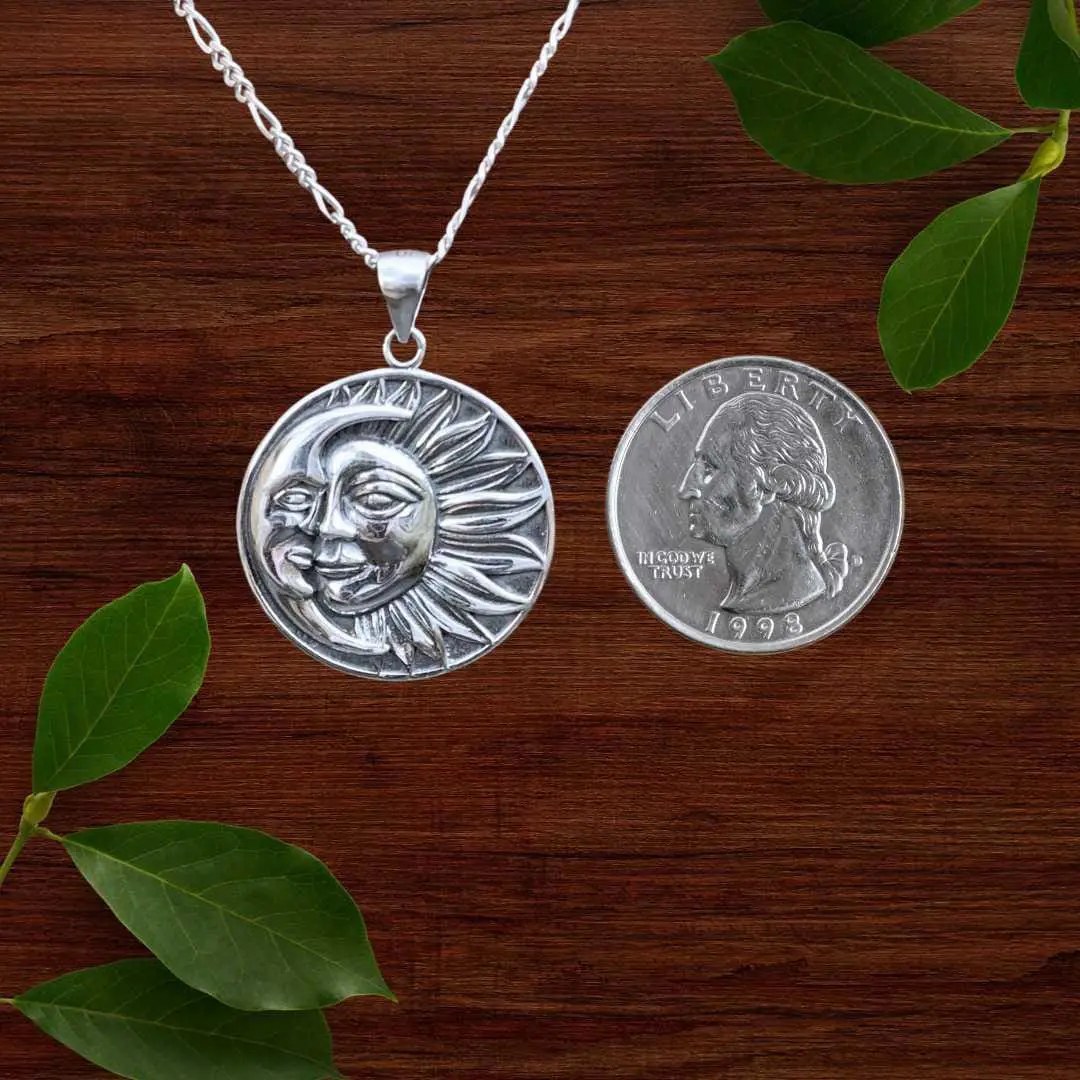 an image of a Celestial Moon and Sun Sterling Silver Pendant next to a quarter