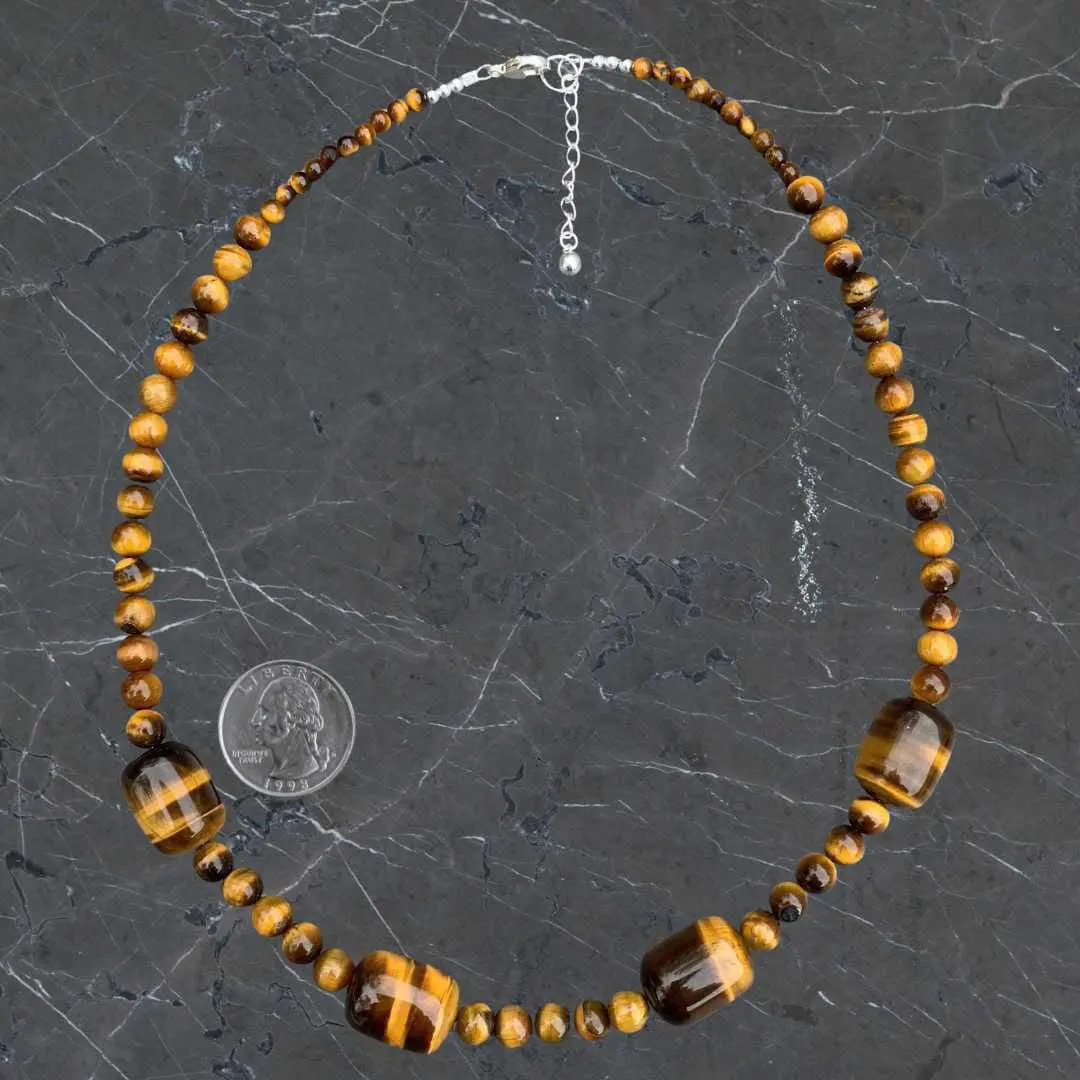 an image of a Barrel and Round Tiger's Eye Beaded Necklace next to a quarter