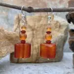 an image of a pair of Square Carnelian Mixed Beaded Earrings with a square carnelian gemstone at the bottom and alternating small rondelle and round beads going up above it.