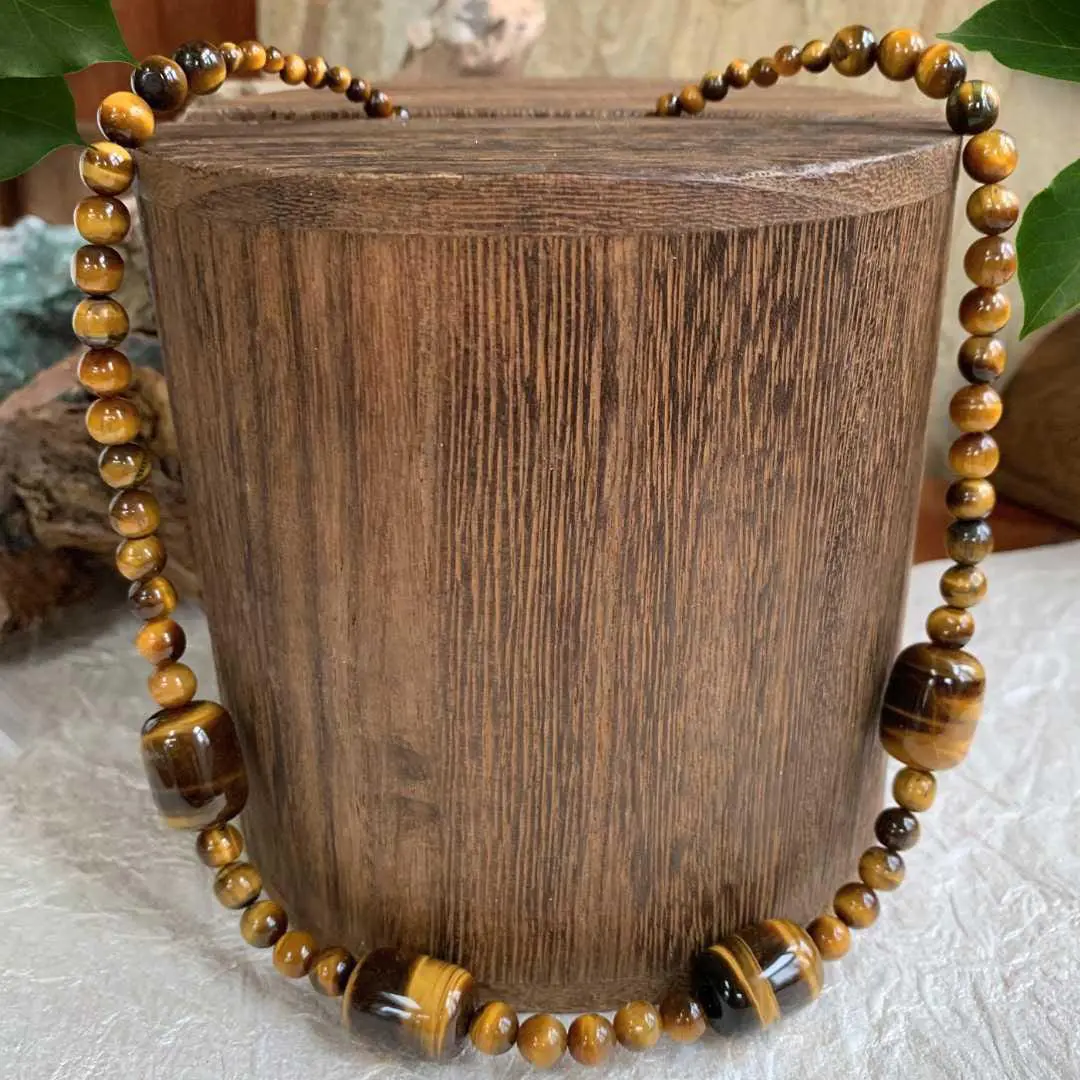 an image of a Barrel and Round Tiger’s Eye Beaded Necklace featuring four large barrel beads with round tiger's eye beads.