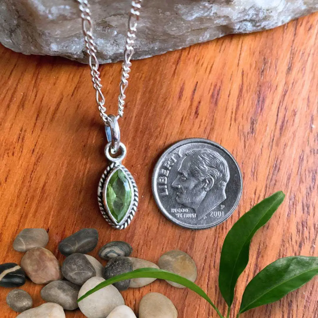 an image of a Petite Marquise Peridot and Sterling Silver Pendant next to a dime