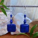 an image of a pair of Square Lapis Lazuli Beaded Earrings showing a square lapis bead on the bottom with smaller rondelle and round beads and a small silver bead from Karen Hill Tribe