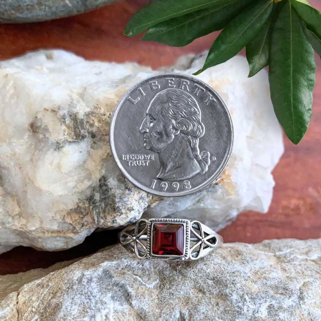an image of a Dainty Square Garnet and Sterling Silver Ring next to a quarter