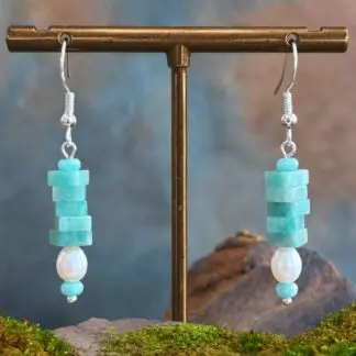 an image of a pair of Square Stacked Amazonite with Pearl Earrings with five 3 x 6 mm square beads stacked on top of a freshwater pearl and framed with a small amethyst rondelle bead on top and bottom. They hang on a sterling silver ear hook.