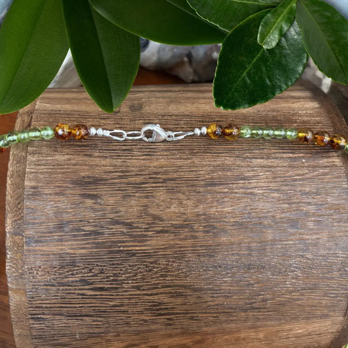 an image of a Peridot and Amber Beaded Necklace showing a closeup of the sterling silver lobster clasp