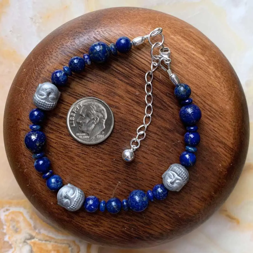 an image of a Hematite Buddhas with Lapis Lazuli Bracelet next to a dime