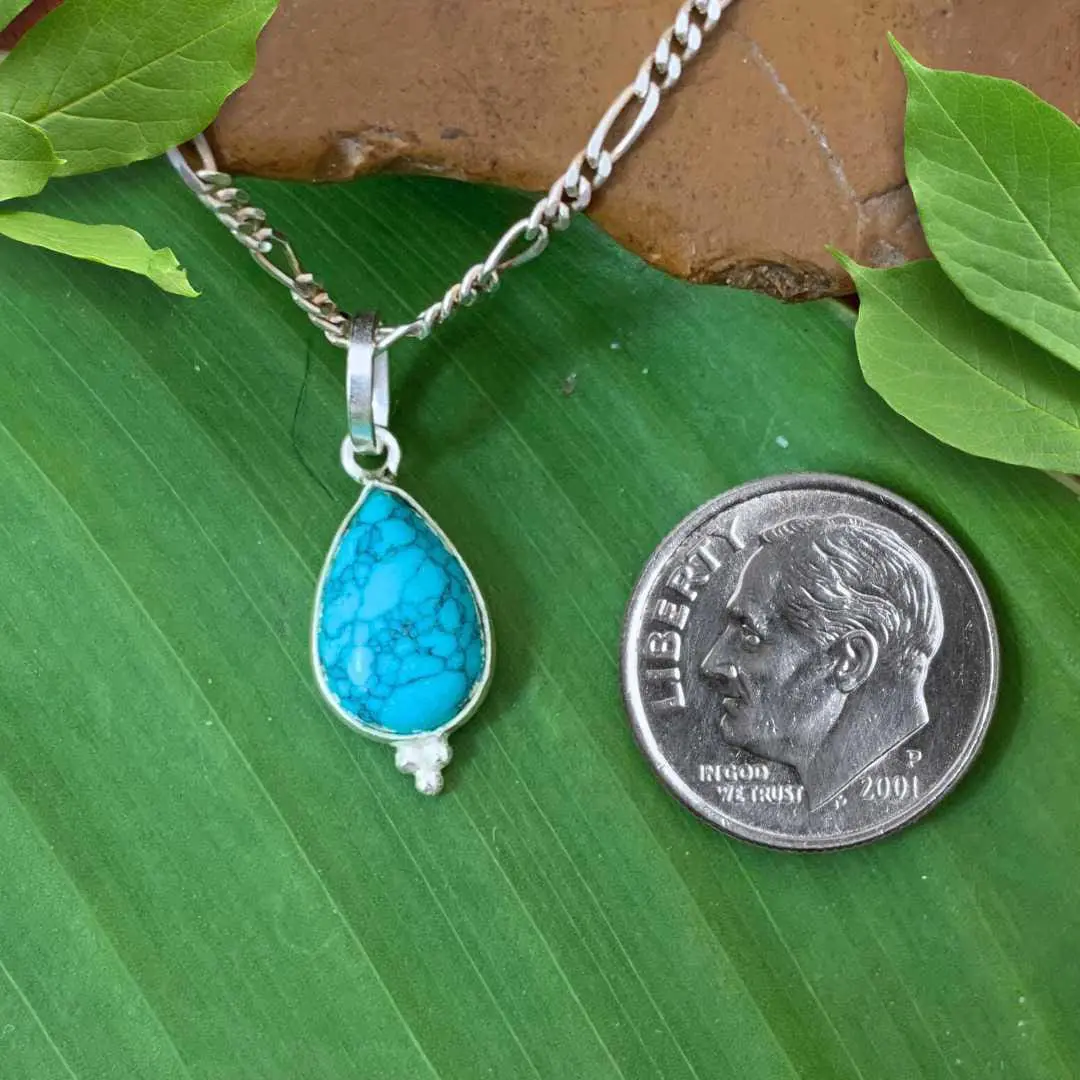 an image of a Petite Teardrop Turquoise and Sterling Silver Pendant next to a dime