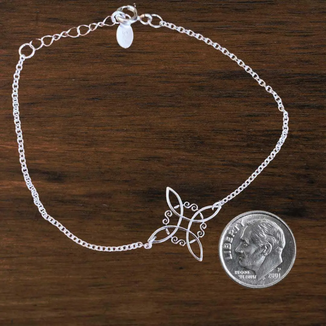 an image of a Sterling Silver Celtic Knot Bracelet next to a dime