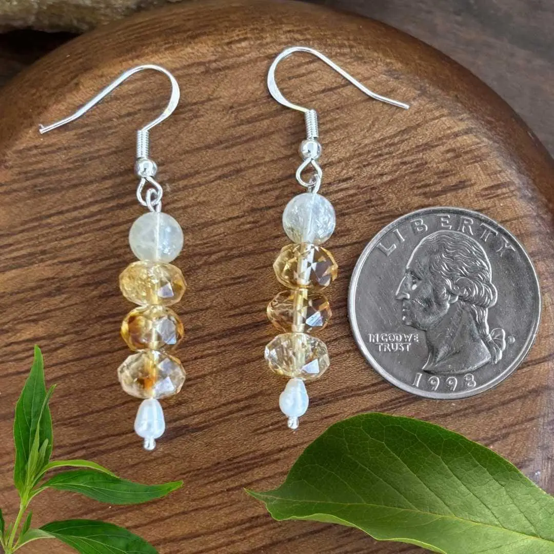 an image of a pair of Stacked Citrine and Pearl Dangle Earrings next to a quarter