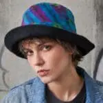an image of a Tie Dye Cotton Bucket Hat with the brim turned up on an AI generated model