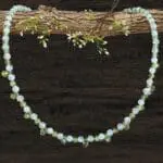 an image of a dainty Faceted Peridot and Rainbow Moonstone Necklace with 4mm faceted rainbow moonstone and peridot beads and eleven faceted small teardrop Peridot beads as focal pieces