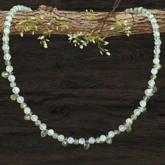 an image of a dainty Faceted Peridot and Rainbow Moonstone Necklace with 4mm faceted rainbow moonstone and peridot beads and eleven faceted small teardrop Peridot beads as focal pieces