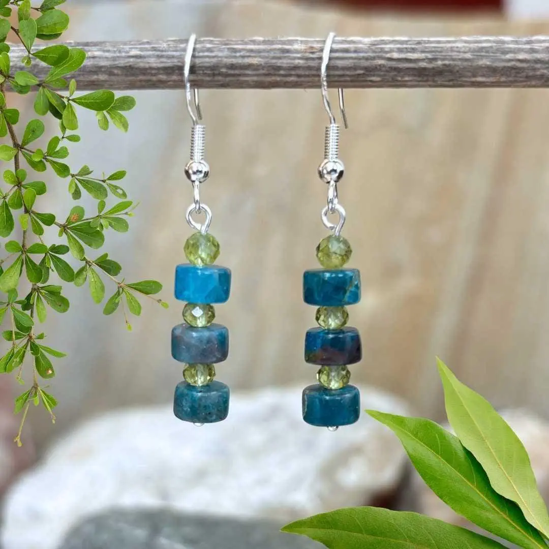 an image of a pair of Apatite Heishi and Faceted Peridot Earrings with three apatite Heishi beads and three 4mm faceted peridot earrings in a stack design on a sterling silver ear hook