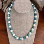 an image of a Round Apatite and Mother of Pearl Beaded Necklace with alternating apatite and mother of pearl beads that are each 10mm in size. It is finished off with sterling beads and lobster clasp