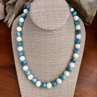 an image of a Round Apatite and Mother of Pearl Beaded Necklace with alternating apatite and mother of pearl beads that are each 10mm in size. It is finished off with sterling beads and lobster clasp