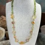 an image of a Citrine and Peridot Gemstone Necklace with assorted shapes of citrine beads and small round peridot beads and peridot small nuggets