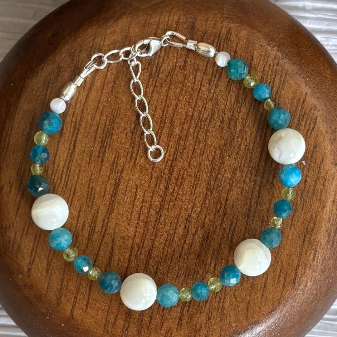 an image of a Mother of Pearl with Apatite and Peridot Beaded Bracelet finished with sterling silver beads and lobster clasp and 1.5 inch sterling silver extension chain